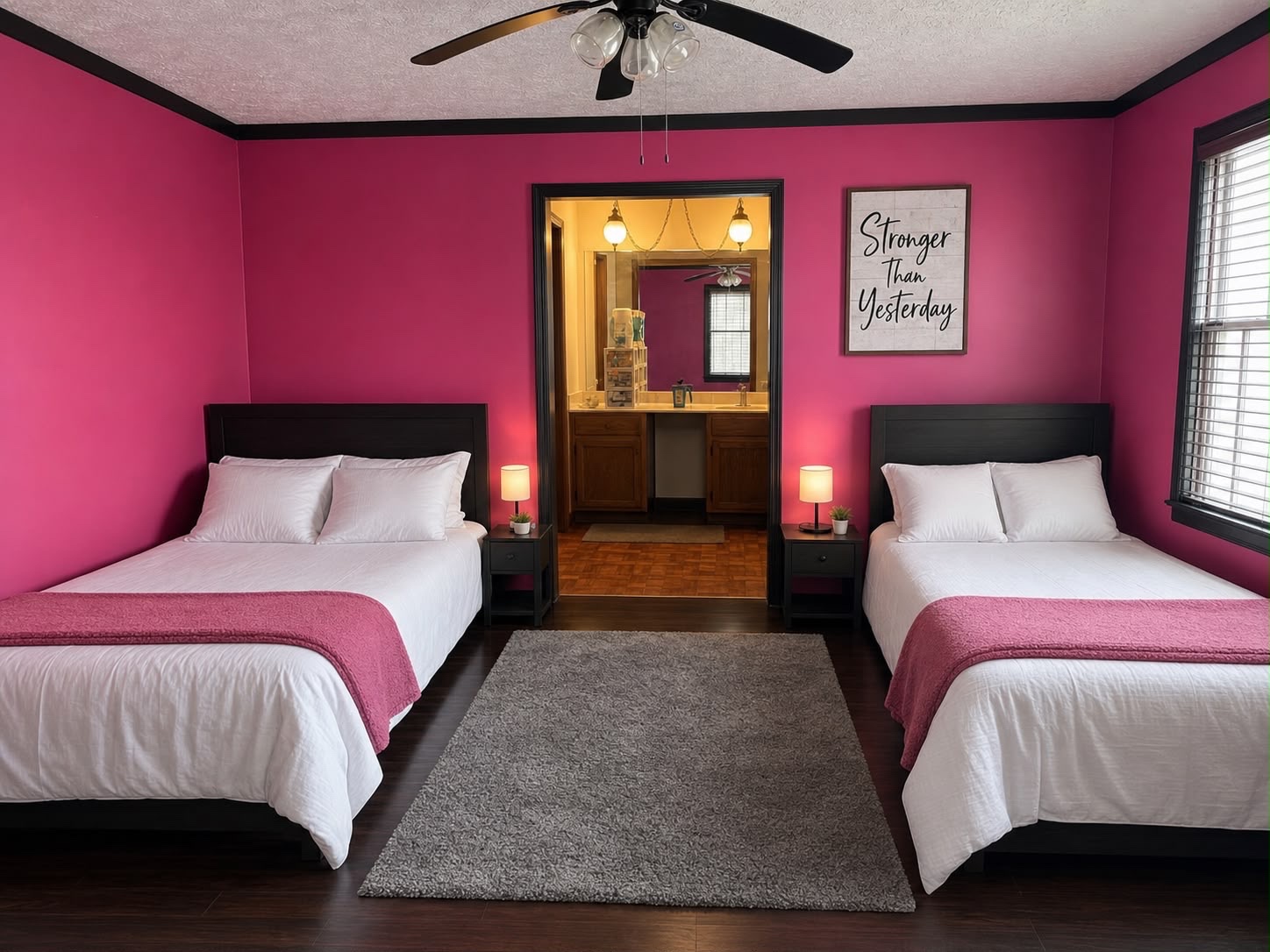 Magenta ensuite bedroom with 2 full-size beds and private bathroom access