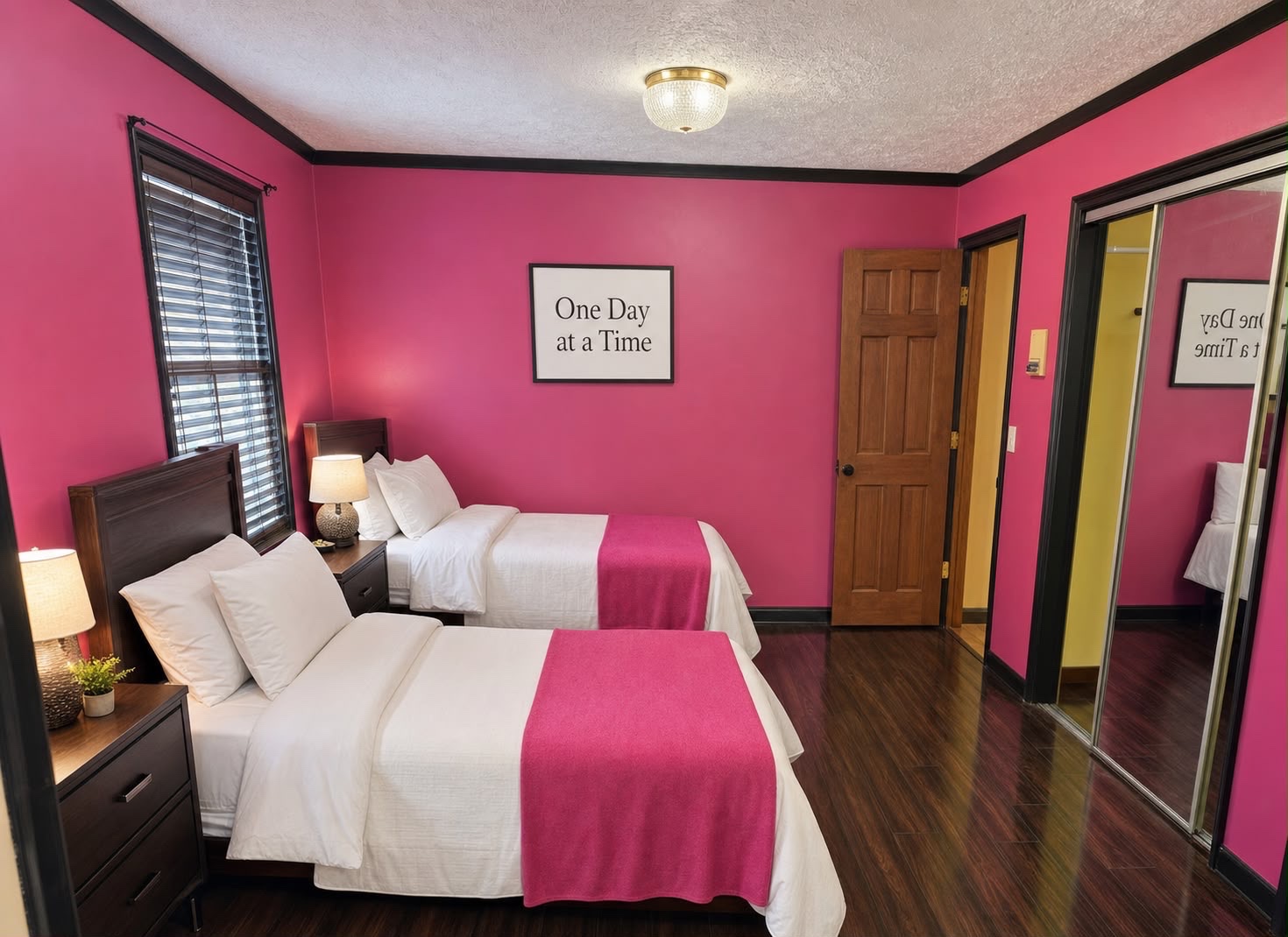 Pink bedroom with mirrored closet and 2 twin beds, hot pink walls